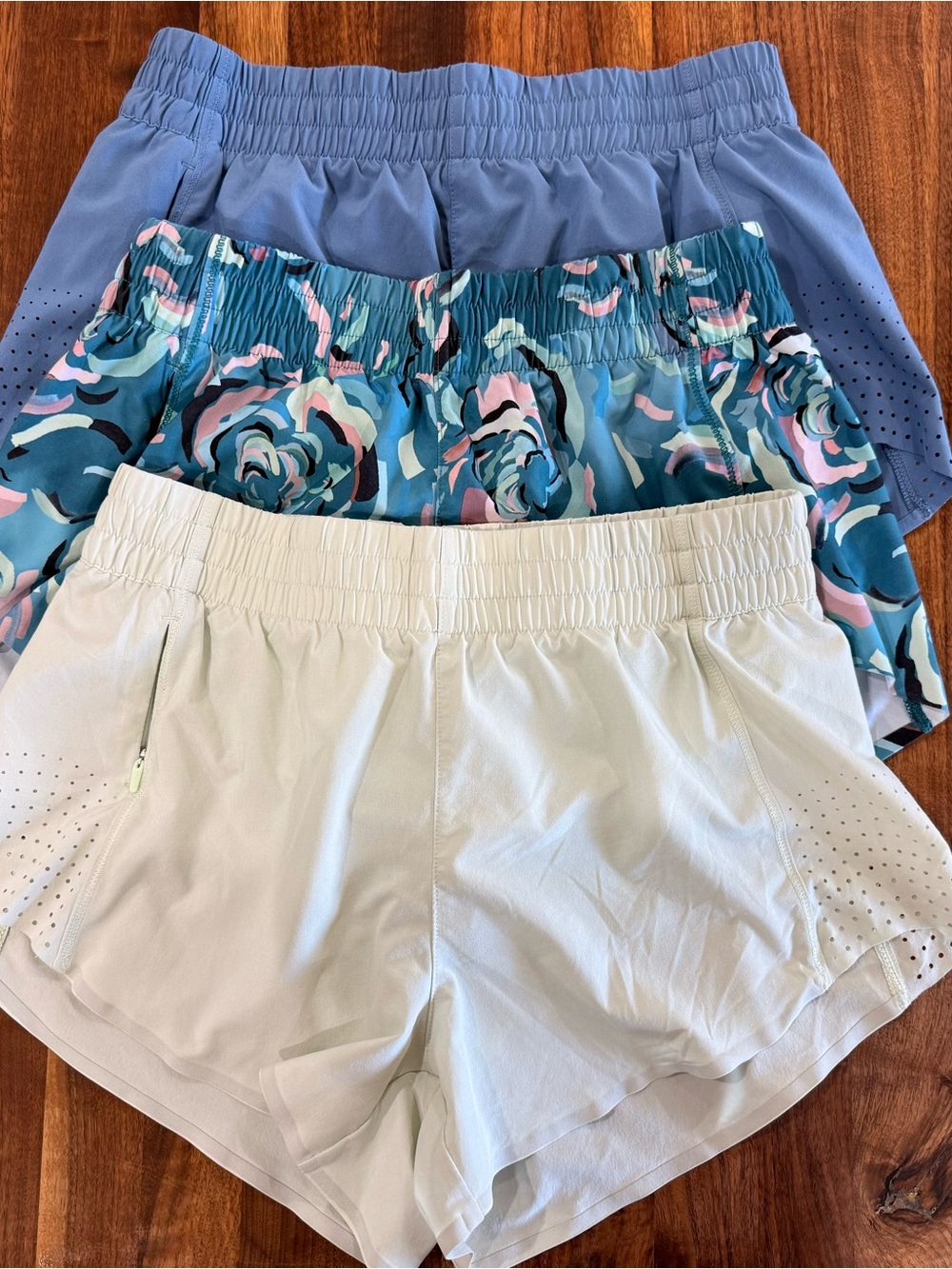 Athleta Hustle 3” Three-Pack Athletic Shorts in Blue, Teal Floral & Light Green